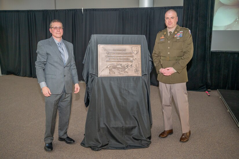 Photo of Jeremy Buratt and Col Kilgore standing alongside of the plaque