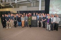 Group photo surrounding the plaque