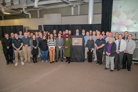 Group photo surrounding the plaque