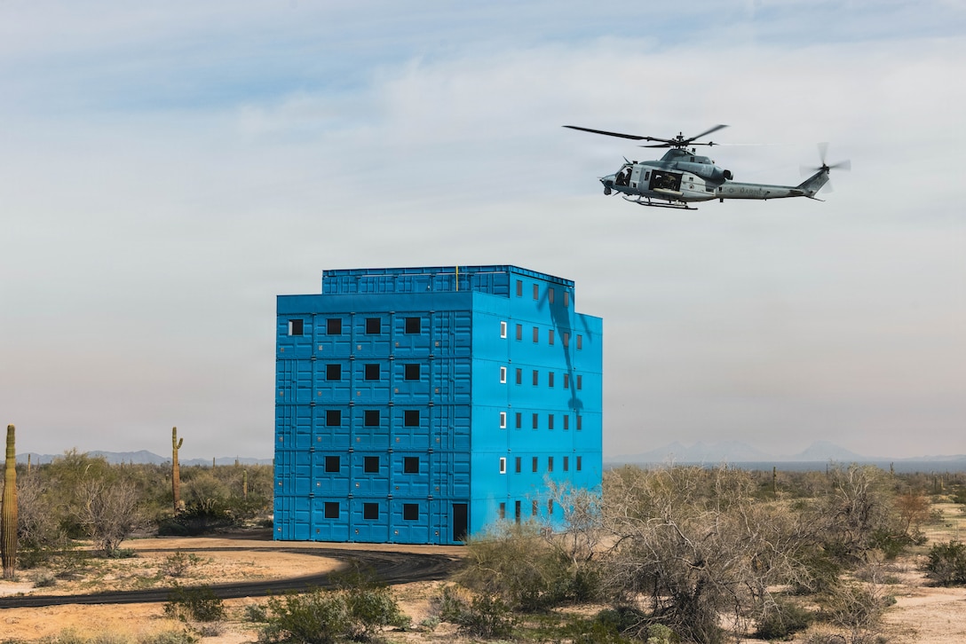 A U.S. Marine UH-1Y Venom helicopter assigned to Marine Operational Test & Evaluation Squadron 1, conducts simulated rooftop inserts at Deuce Village in the Berry M. Goldwater Ranges, Yuma, Arizona, Jan. 21, 2025. This exercise showcased Marine Corps Air Station Yuma’s capabilities to facilitate complex aerial training in an urban environment. (U.S. Marine Corps photo by Lance Cpl. Alexandria Serrano)