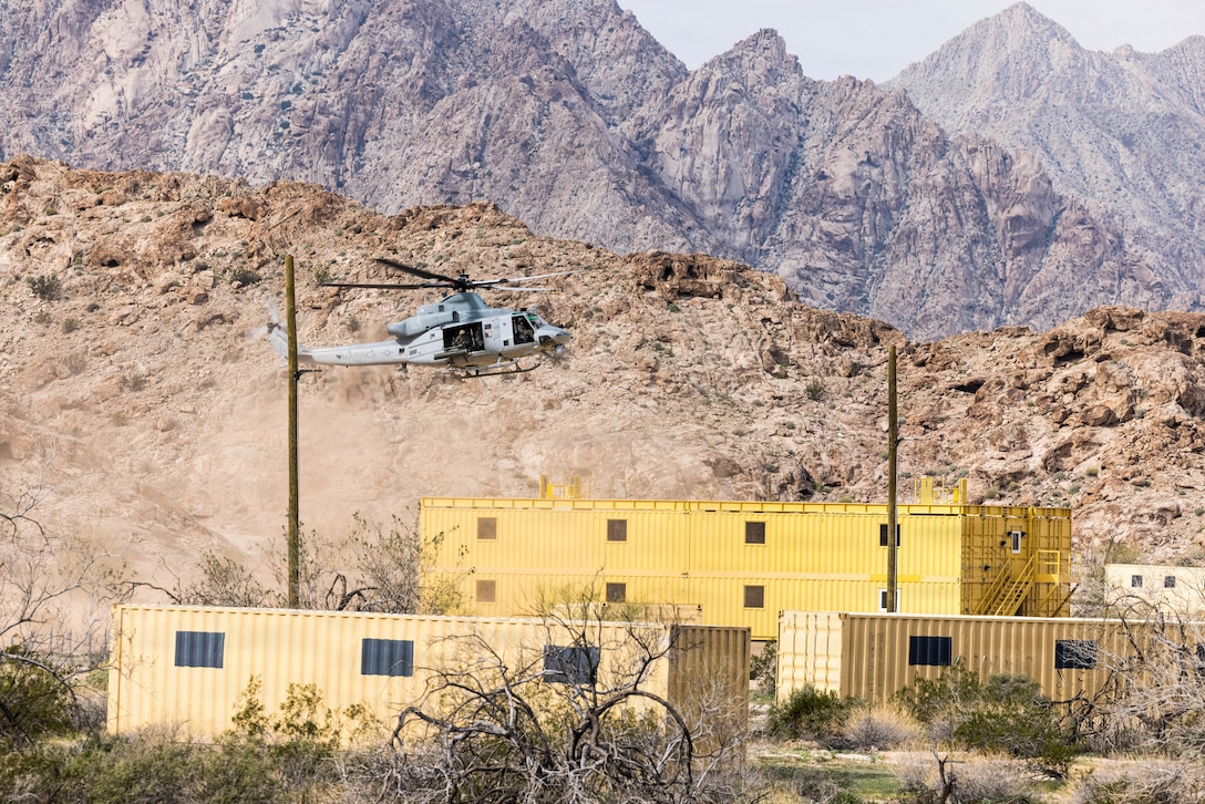 A U.S. Marine UH-1Y Venom helicopter assigned to Marine Operational Test & Evaluation Squadron 1, conducts simulated rooftop inserts at Deuce Village in the Berry M. Goldwater Ranges, Yuma, Arizona, Jan. 21, 2025. This exercise showcased Marine Corps Air Station Yuma’s capabilities to facilitate complex aerial training in an urban environment. (U.S. Marine Corps photo by Lance Cpl. Alexandria Serrano)