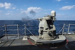 SOUTH CHINA SEA - Arleigh Burke-class guided-missile destroyer USS Mustin (DDG 89) fires its MK 38 25 mm gun during a live-fire drill in 2015. The weapon has since been upgraded to MK 38 MOD 4, which employes a 30 mm gun and integrates with the Aegis Combat System. (U.S. Navy photo by Mass Communication Specialist Seaman David Flewellyn/Released)