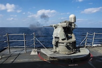 SOUTH CHINA SEA - Arleigh Burke-class guided-missile destroyer USS Mustin (DDG 89) fires its MK 38 25 mm gun during a live-fire drill in 2015. The weapon has since been upgraded to MK 38 MOD 4, which employes a 30 mm gun and integrates with the Aegis Combat System. (U.S. Navy photo by Mass Communication Specialist Seaman David Flewellyn/Released)