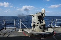 SOUTH CHINA SEA - Arleigh Burke-class guided-missile destroyer USS Mustin (DDG 89) fires its MK 38 25 mm gun during a live-fire drill in 2015. The weapon has since been upgraded to MK 38 MOD 4, which employes a 30 mm gun and integrates with the Aegis Combat System. (U.S. Navy photo by Mass Communication Specialist Seaman David Flewellyn/Released)