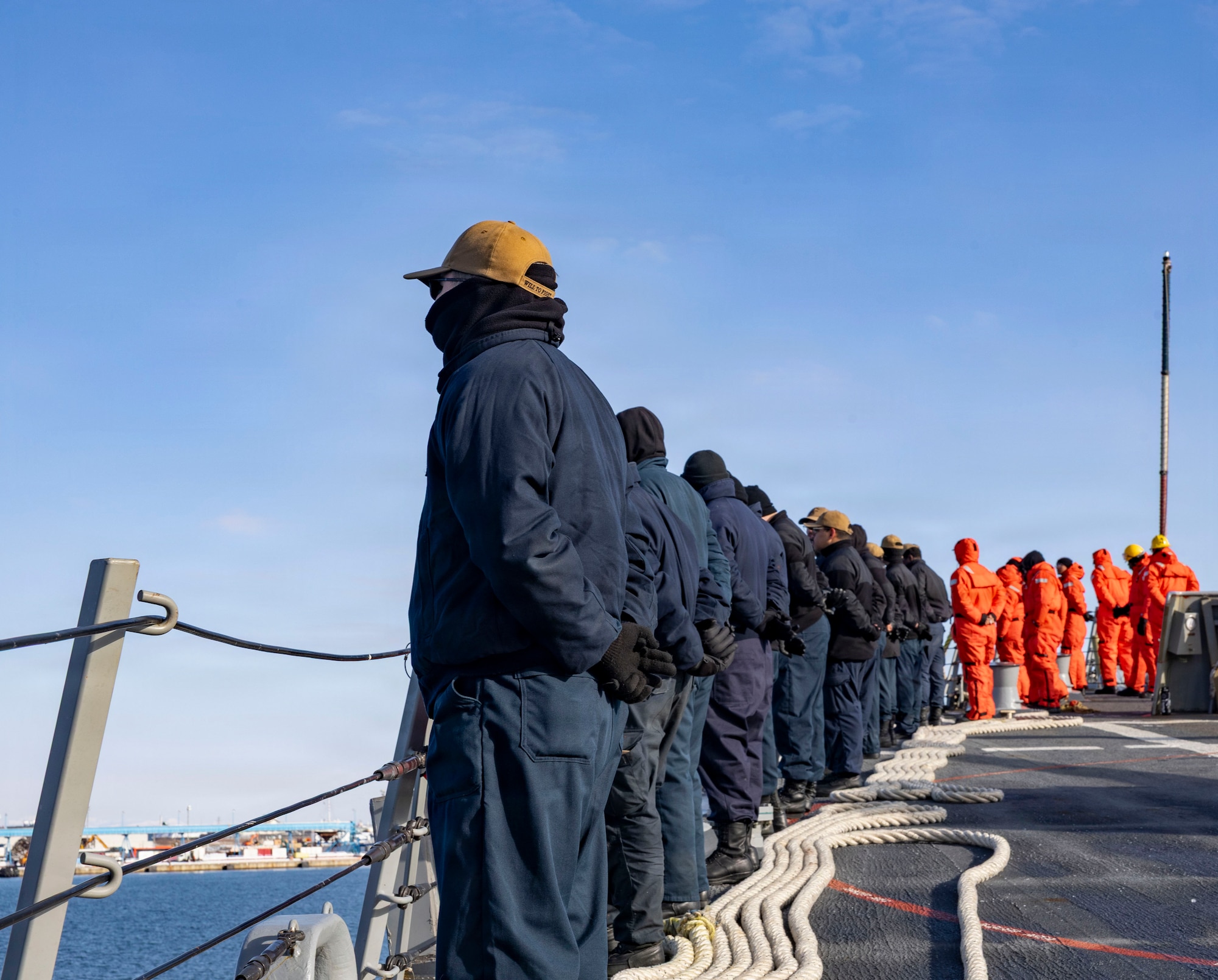 U.S. Navy Sailors man the rails along the fo’c’sle aboard Arleigh Burke-class missile-guided destroyer USS Dewey (DDG 105), during a sea and anchor evolution off the coast of Kushiro, Japan, Jan. 29, 2026. Dewey is forward deployed and assigned to Destroyer Squadron (DESRON) 15, the Navy’s largest DESRON and the U.S. 7th Fleet’s principal surface force. (U.S. Navy photo by Mass Communication Specialist 2nd Class Oscar Diaz)