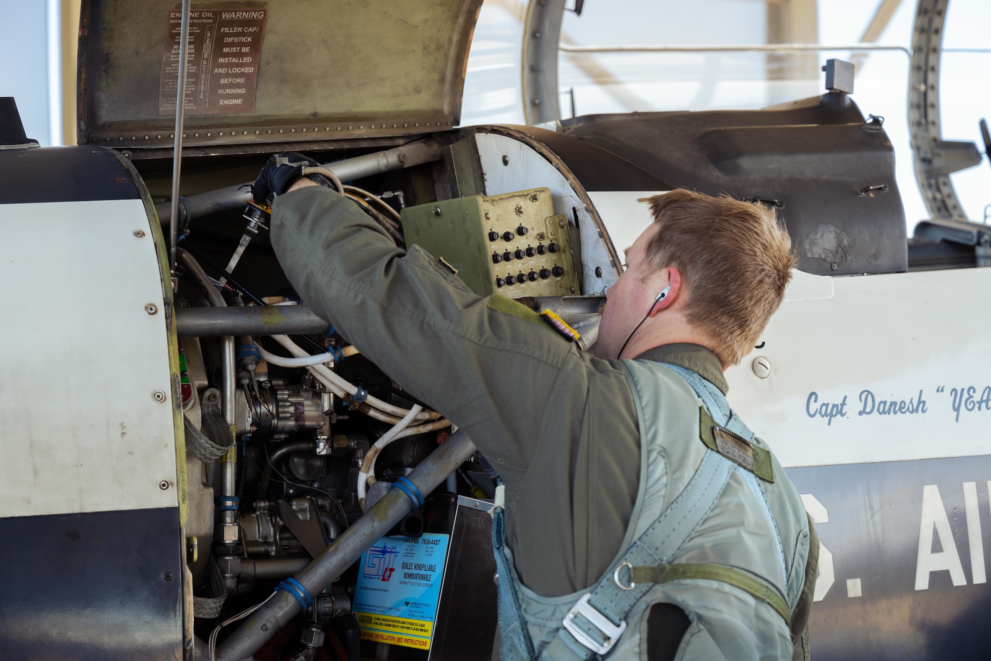 U.S. Air Force Capt. Dane Butler, 85th Flying Training Squadron, instructor pilot, checks the engine oil on a T-6A Texan II during Rapid Crew Swap operations at Laughlin Air Force Base, Texas, Jan. 29, 2026. By allowing pilots to perform through-flight inspections, the wing reduces ground time between sorties, increases aircraft availability, and supports future undergraduate pilot training production requirements. (U.S. Air Force photo by Airman 1st Class Harrison Sullivan)