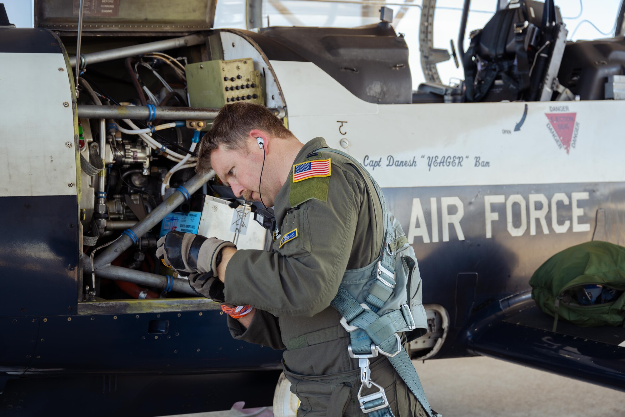 U.S. Air Force Capt. Dane Butler, 85th Flying Training Squadron, instructor pilot, checks the engine oil on a T-6A Texan II during Rapid Crew Swap operations at Laughlin Air Force Base, Texas, Jan. 29, 2026. The procedure enables aircraft to return to flight more quickly by removing the requirement for maintenance inspections between local sorties, increasing operational efficiency and pilot throughput. (U.S. Air Force photo by Airman 1st Class Harrison Sullivan)
