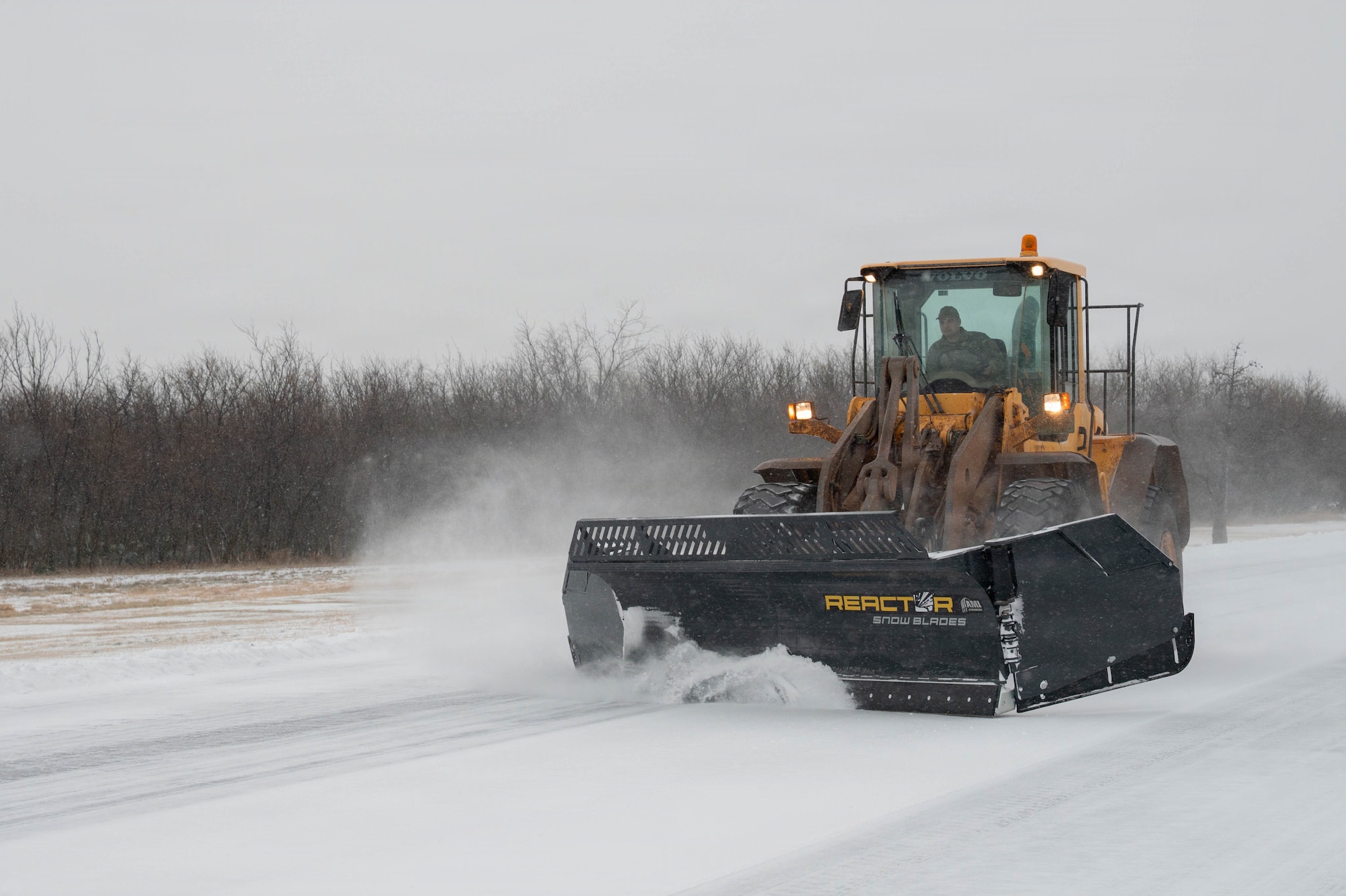 A U.S. Airman assigned to the 7th Civil Engineer Squadron removes ice during Winter Storm Fern at Dyess Air Force Base, Texas, Jan. 24, 2026. The storm struck on the second day of the 7th Bomb Wing’s Combat Readiness Exercise, depositing approximately three-quarters of an inch of ice and two inches of snow across the installation. The 7th CES reorganized operations to prepare infrastructure and accelerate timelines to reopen the airfield for safe flight operations. (U.S. Air Force photo by Airman William Neal)