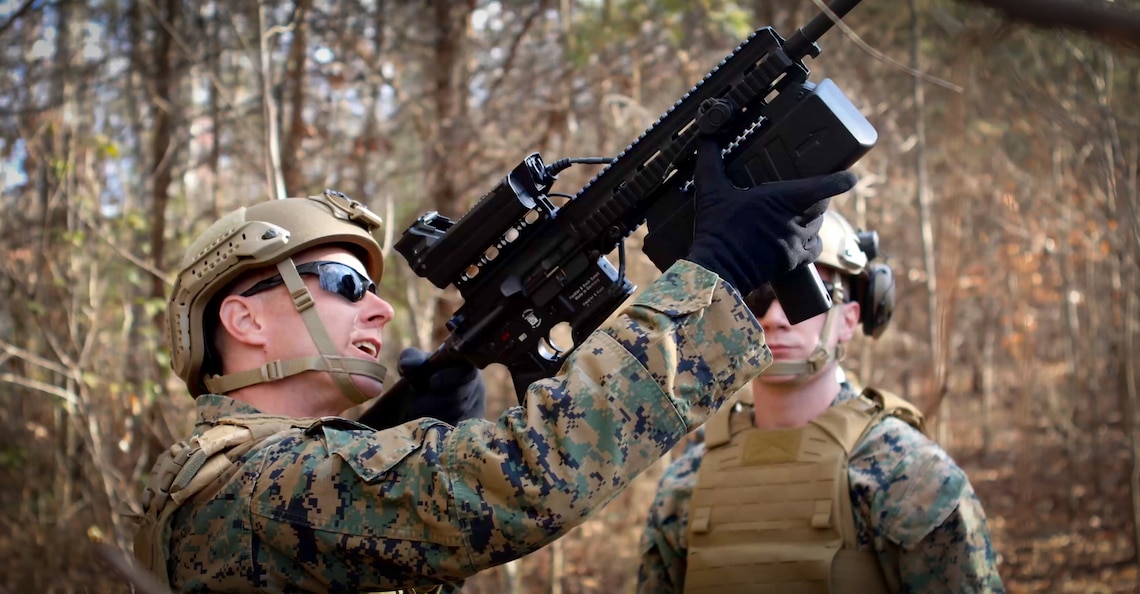 Two Marines working together on the deployment of the Organic Counter Small UAS