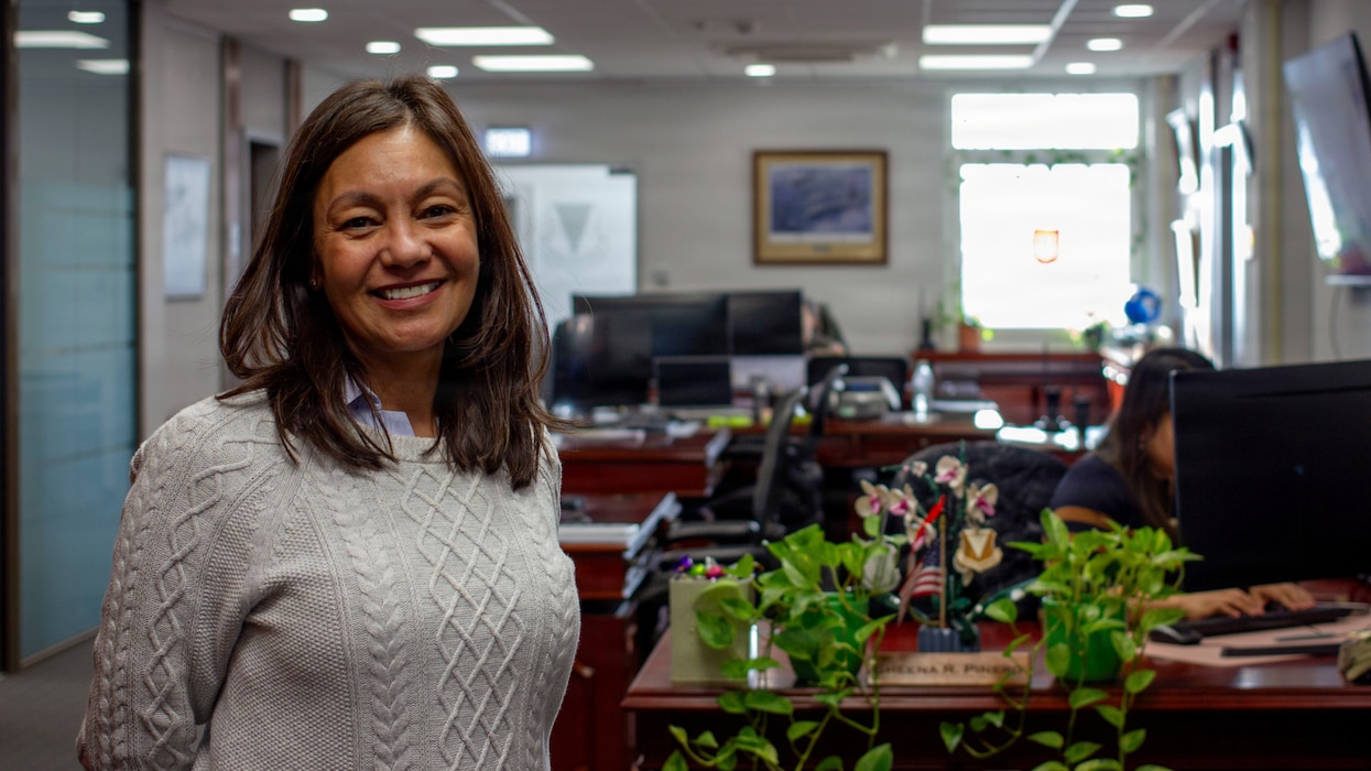 Mrs. Fischer poses for a photo in her office space.