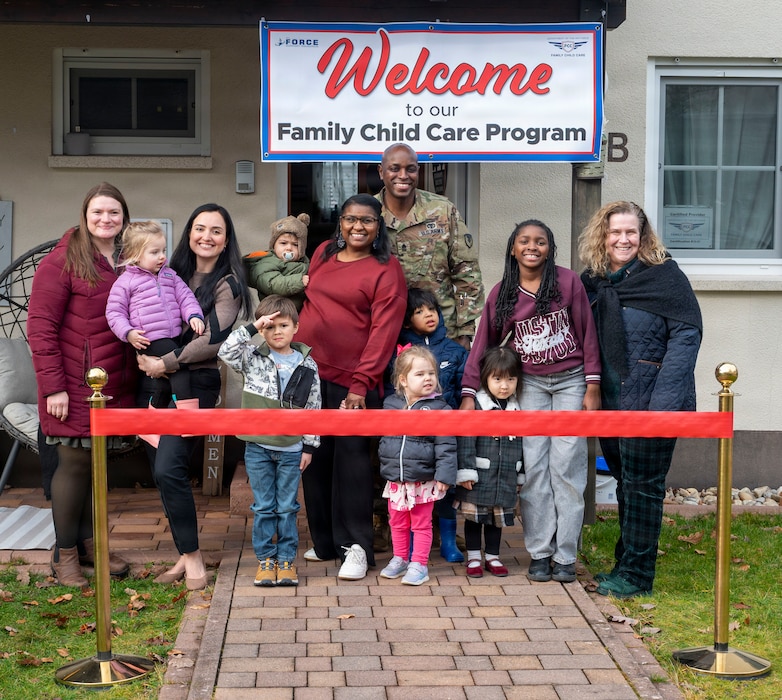people pose for ribbon cutting