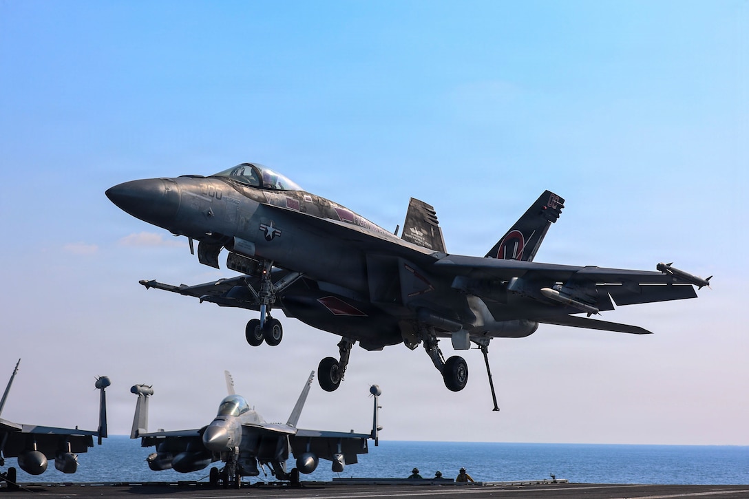 An F/A-18E Super Hornet, attached to Strike Fighter Squadron (VFA) 14, prepares to make an arrested landing on the flight deck of Nimitz-class aircraft carrier USS Abraham Lincoln (CVN 72) in the Arabian Sea, Jan. 30, 2026. Abraham Lincoln is deployed to the U.S. 5th Fleet area of operations to support maritime security and stability in the U.S. Central Command area of responsibility. (U.S. Navy photo by Mass Communication Specialist Seaman Hannah Tross)