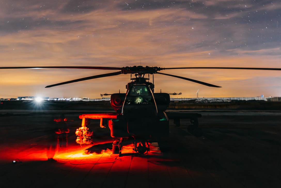 U.S. Soldiers assigned to 4th Combat Aviation Brigade prepare AH-64 Apache helicopters for Operation Hawkeye Strike within the U.S. Central Command area of responsibility, Dec. 19, 2025. (U.S. Army photo by Sgt. Zachary Ta)
