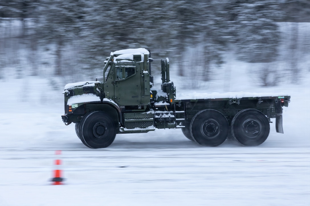 A U.S. Marine with Combat Logistics Battalion 6, Combat Logistics Regiment 2, 2nd Marine Logistics Group, drives a Medium Tactical Vehicle Replacement around cones during a slippery driver training course in Setermoen, Norway, Jan. 26, 2026. This Norwegian-led course provides drivers with essential techniques for operating tactical vehicles safely in icy and snowy conditions. Exercise Cold Response 26 is a Norwegian-led winter military exercise designed to enhance collective defense capabilities and ensure U.S. readiness to rapidly deploy and seamlessly operate alongside NATO Allies in challenging arctic conditions. (U.S. Marine Corps photo by Cpl. Apollo Wilson)