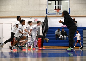 Military dependents run down a basketball court during a Hoops for Troops youth basketball clinic hosted by the Washington Wizards at Joint Base Anacostia-Bolling, Washington, D.C., Jan. 23, 2026. The Wizards hosted the event at the installation to give back to military families and teach basketball drills to children. (U.S. Air Force photo by Tech. Sgt. Sergio A. Gamboa)