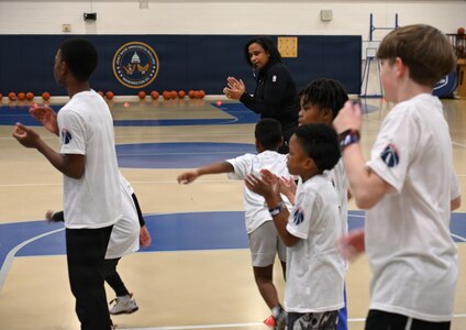 Military dependents learn basketball drills during a Hoops for Troops youth basketball clinic hosted by the Washington Wizards at Joint Base Anacostia-Bolling, Washington, D.C., Jan. 23, 2026. The Wizards hosted the clinic for military families where children learned and improved on shooting, passing, dribbling, and defense techniques. (U.S. Air Force photo by Tech. Sgt. Sergio A. Gamboa)