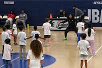 Military dependents learn basketball drills during a Hoops for Troops youth basketball clinic hosted by the Washington Wizards at Joint Base Anacostia-Bolling, Washington, D.C., Jan. 23, 2026. The Wizards hosted the clinic for military families where children learned and improved on shooting, passing, dribbling, and defense techniques. (U.S. Air Force photo by Tech. Sgt. Sergio A. Gamboa)