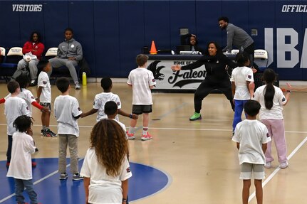 Military dependents learn basketball drills during a Hoops for Troops youth basketball clinic hosted by the Washington Wizards at Joint Base Anacostia-Bolling, Washington, D.C., Jan. 23, 2026. The Wizards hosted the clinic for military families where children learned and improved on shooting, passing, dribbling, and defense techniques. (U.S. Air Force photo by Tech. Sgt. Sergio A. Gamboa)