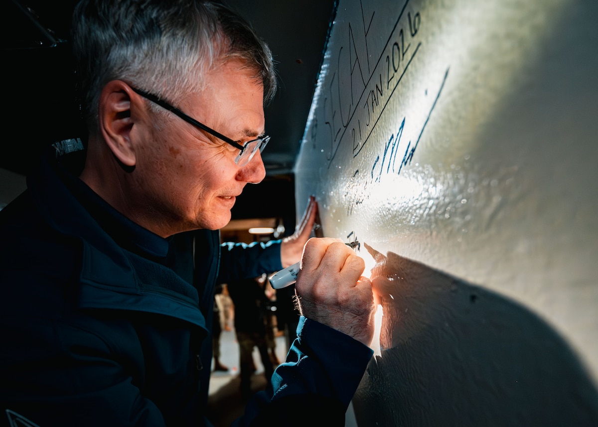 Secretary of the Air Force Troy Meink signs a wall during a tour of a launch control center at Missile Alert Facility A-01 near Albin, Wyo., Jan. 21, 2026. Meink's visit focused on assessing how 90th Missile Wing Airmen are maintaining mission readiness while preparing for future intercontinental ballistic missile modernization. (U.S. Air Force photo by Staff Sgt. Michael A. Richmond)