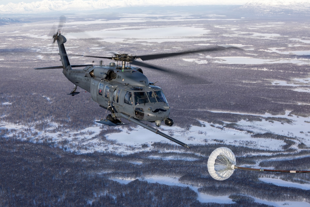 An HH-60G Pave Hawk from the 210th Rescue Squadron, Alaska Air National Guard, approaches a refueling drogue during training over Southcentral Alaska, Jan. 29, 2026. The HH-60G is the 176th Wing’s primary personnel recovery platform, capable of all-weather operations and employing a rescue hoist when landing is not possible. (Alaska Air National Guard photo by Alejandro Peña)