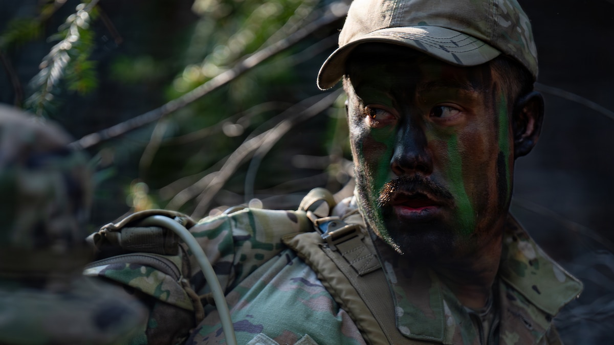 Tech. Sgt. Timothy French, 60th Logistics Readiness Squadron noncommissioned officer in charge of individual protective equipment, applies camouflage during Survival, Evasion, Resistance and Escape training in California, Jan. 30, 2026. SERE face paint is a tactical, sweat-proof camouflage used to reduce an Airman’s visibility and infrared signature in various environments. (U.S. Air Force photo by Senior Airman Robert Nichols)