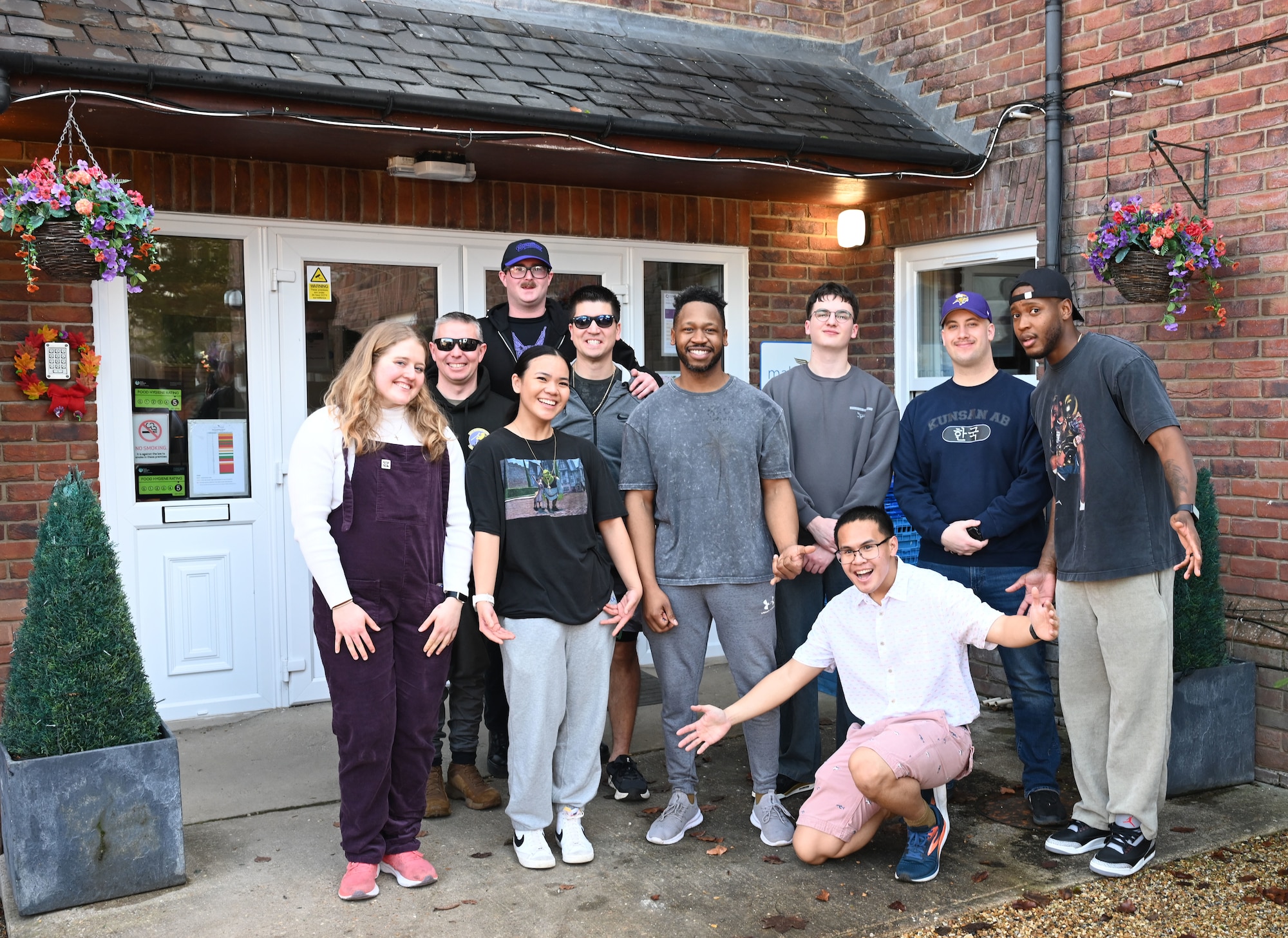 U.S. Airmen with the RAF Mildenhall Top 3, 100th Civil Engineer Squadron and 100th Communications Squadron pose for a photo after spending an afternoon singing karaoke for residents at Mabbs Hall Care Home, Mildenhall, England, Jan. 28, 2026. Team Mildenhall Airmen regularly volunteer within the local area to strengthen partnerships and build community relations. (U.S. Air Force photo by Karen Abeyasekere)