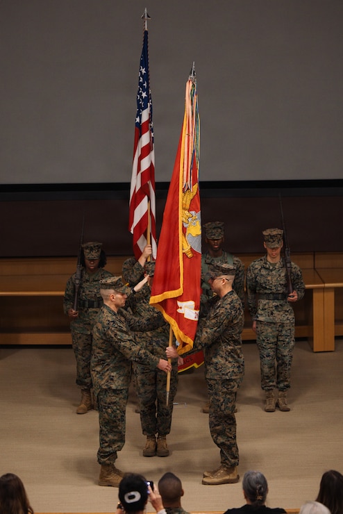 U.S. Marine Corps Col. Ben Reid, right, the outgoing commanding officer of the 26th Marine Expeditionary Unit, passes the unit colors to Col. Michael Stansberry, the incoming commanding officer, during the 26th MEU change of command ceremony at Marine Corps Base Camp Lejeune, North Carolina, Feb. 5, 2026. A change of command ceremony signifies the transfer of responsibility, authority and accountability from one commander to another. (U.S. Marine Corps photo by Sgt. Jorge Borjas)