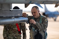 Airman inspecting F-16