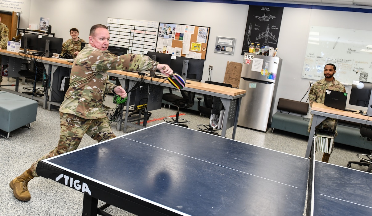 Chief Master Sergeant Andrew J. McKendree, Sixteenth Air Force (Air Forces Cyber) command chief, smashes a ping pong ball during an impromptu game during his visit to the 55th Maintenance Group, Jan. 13, 2026. The 55th MXG has more than 1,200 personnel providing maintenance to 27 aircraft comprised of the variations of five different aircraft. (U.S. Air Force photo by Chad Watkins)