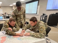 Students assigned to the 13R Advanced Leader Course collaborate during a tactical planning exercise at the 213th Regional Training Institute in Guernsey, Wyoming, Jan. 22, 2026.
