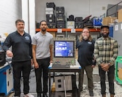 Engineers assigned to Mid-Atlantic Regional Maintenance Center's (MARMC) Submarine Towed Systems Branch (Code 274) pose for a photo with a modernized computer system.