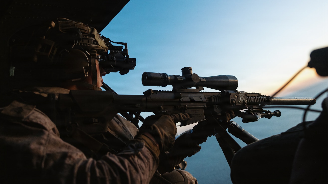 U.S. Marine Corps Sgt. Yoel Rhe, a scout team leader with Weapons Company, Battalion Landing Team 3/5, 11th Marine Expeditionary Unit, provides aerial sniper coverage from a UH-1Y Venom attached to Marine Medium Tiltrotor Squadron (VMM) 163 (Reinforced), 11th MEU, during a visit, board, search and seizure exercise in the Pacific Ocean, Feb. 2, 2026. The 11th MEU is currently underway aboard the Boxer Amphibious Ready Group in the U.S. 3rd Fleet area of operations conducting integrated training that enhances lethality and warfighting readiness. (U.S. Marine Corps photo by Sgt. Joseph Helms)