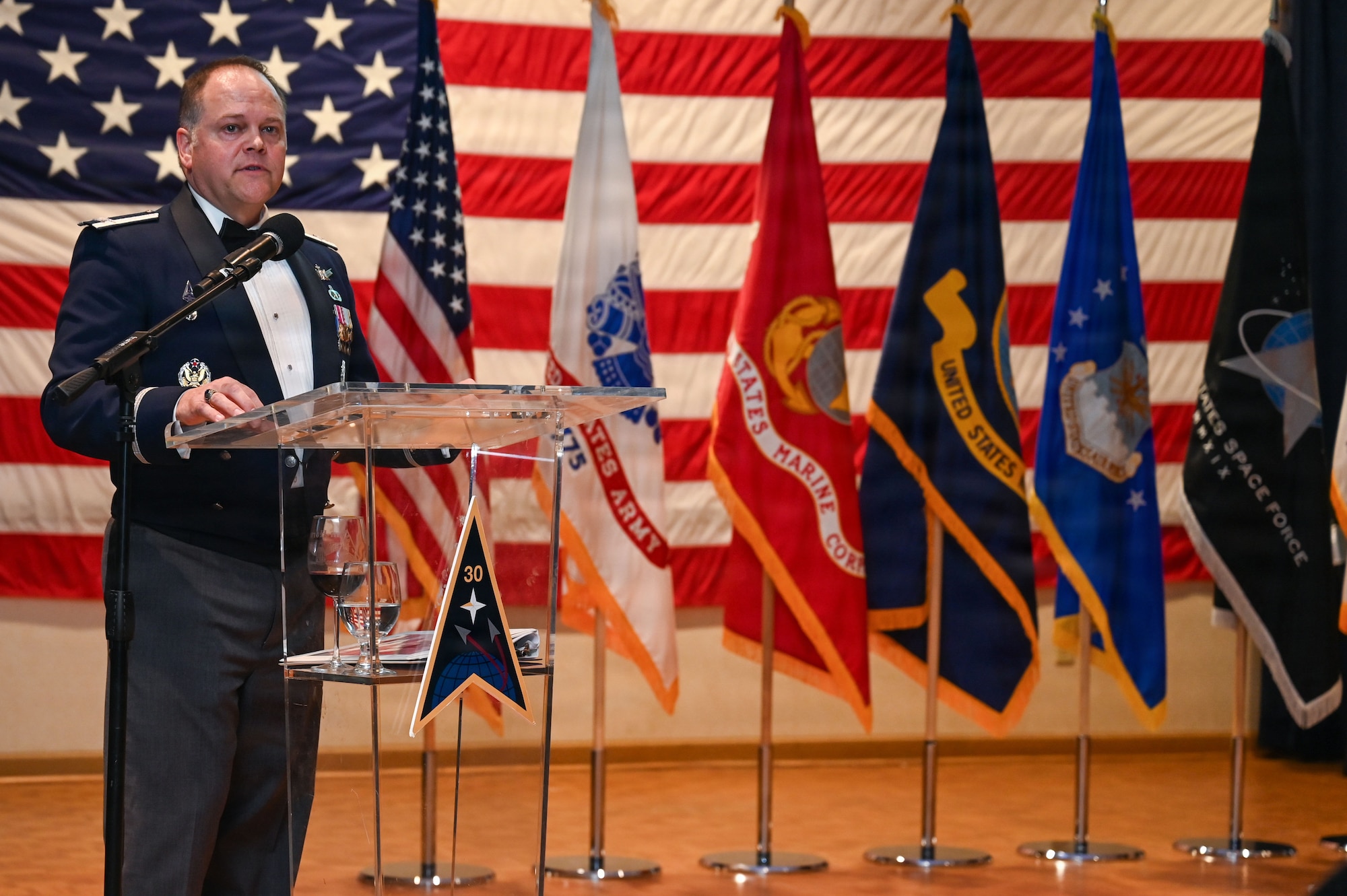 U.S. Space Force Col. James T. Horne III, Space Launch Delta 30 commander, stands behind podium and delivers closing remarks.