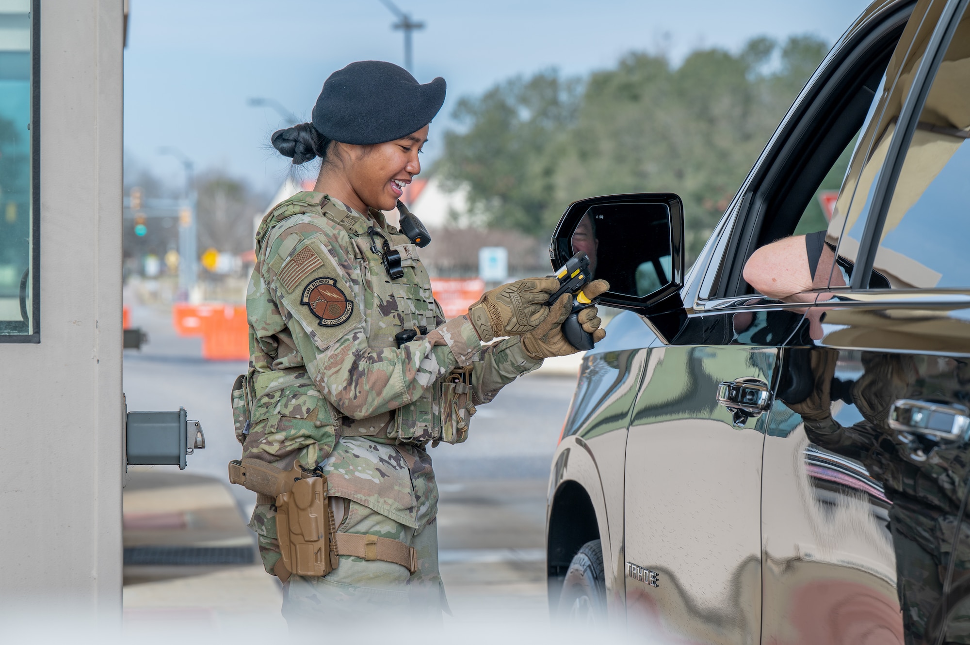 U.S. Air Force Airman Destiny Mel, 42d Security Forces Squadron entry controller, scans an identification card from a driver at Maxwell Air Force Base, Alabama, Feb. 3, 2026.