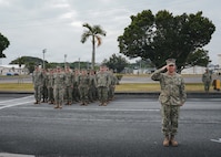 Captain James Angerman (right) Commanding Officer of Naval Mobile Construction Battalion (NMCB) 11, salutes as the battalion flag is raised during the Relief-in-Place / Transfer-of-Authority (RIPTOA) ceremony from NMCB 4 to NMCB 11 on Camp Shields, Okinawa, Japan, Feb. 02, 2026.