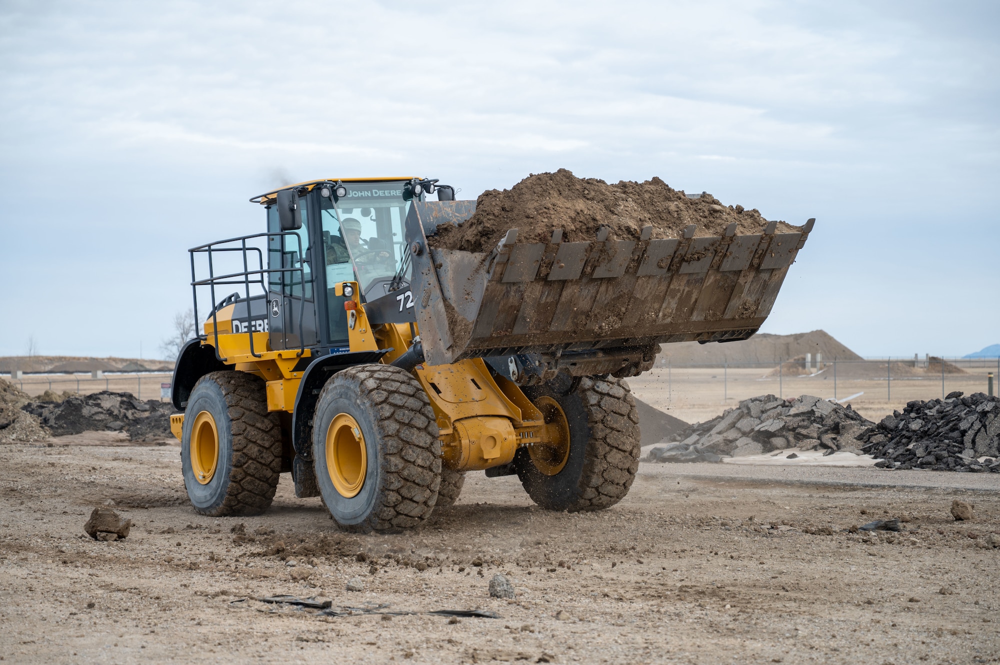 a front-end loader with a bucket full of dirt.