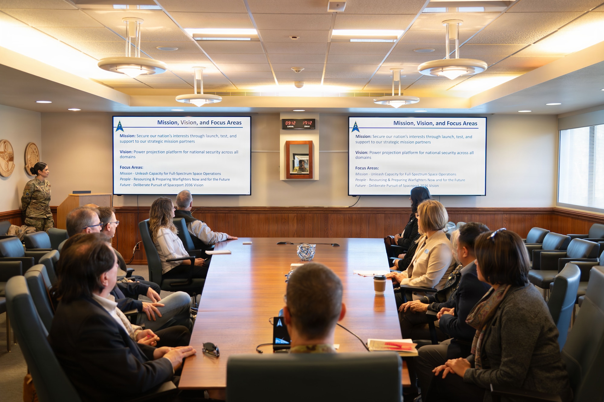 a group of people sit at a conference table