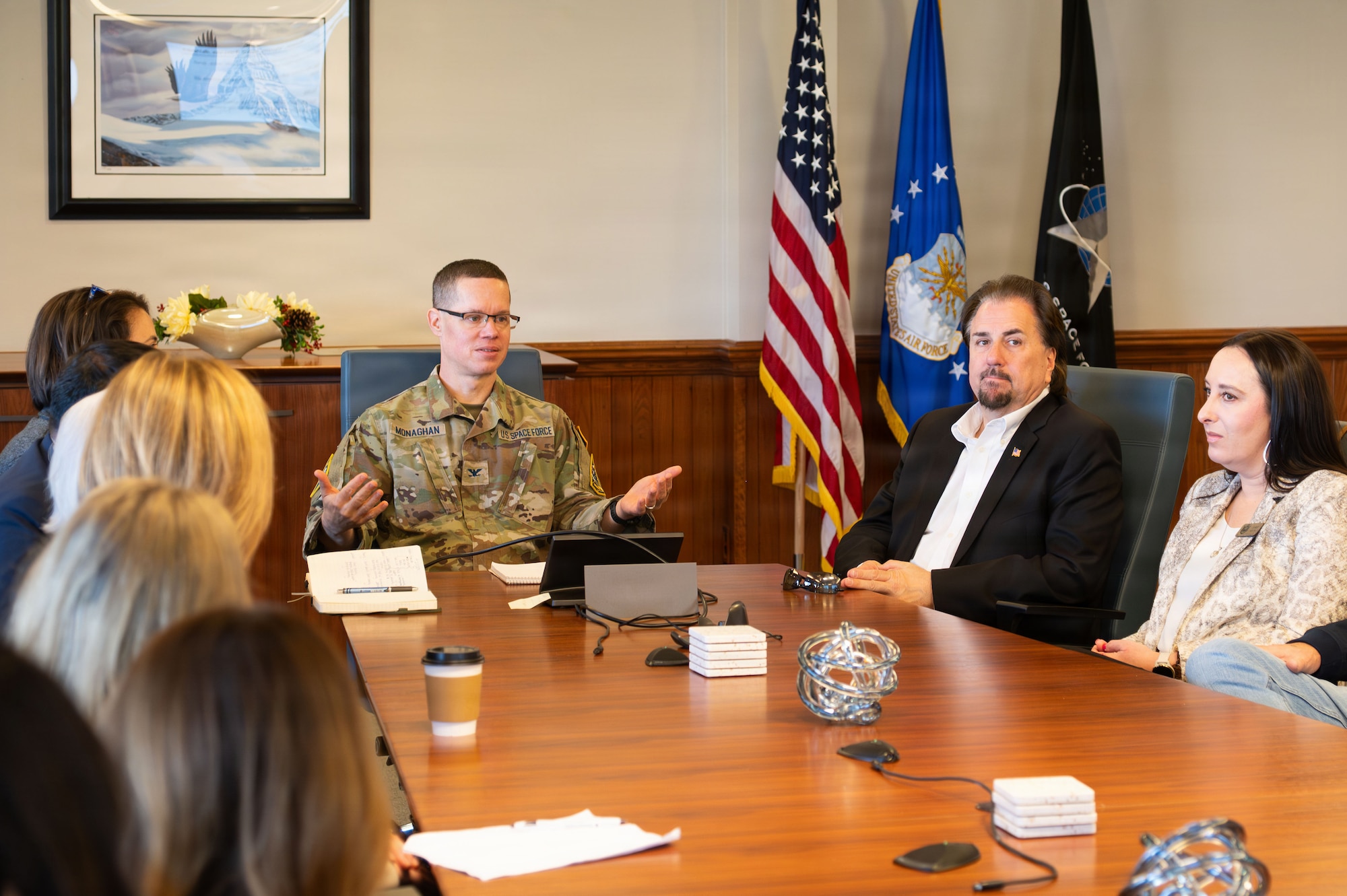 a group of people sit at a conference table