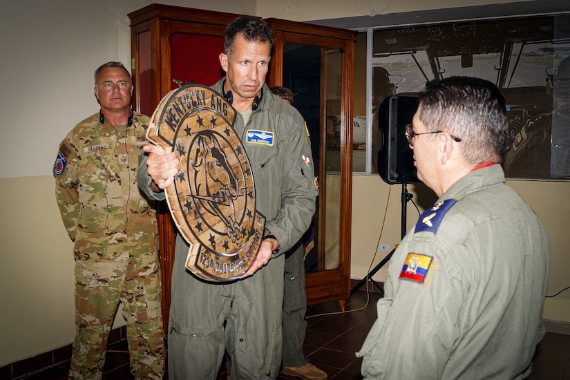 Lt. Col. Rob Anderson of the Kentucky Air National Guard’s 123rd Airlift Wing presents a bourbon barrel head to leaders from the Ecuadorian Air Force’s 11th Transportation Wing during a ceremony held as part of a State Partnership Program joint information exchange at Cotopaxi Air Force Base, Ecuador, May 19-24, 2025. The effort focused on fixed-wing aircrew subjects specific to C-130 Hercules aircraft operations and was designed to strengthen relationships, broaden communication channels and foster more in-person collaboration. (Courtesy photo)