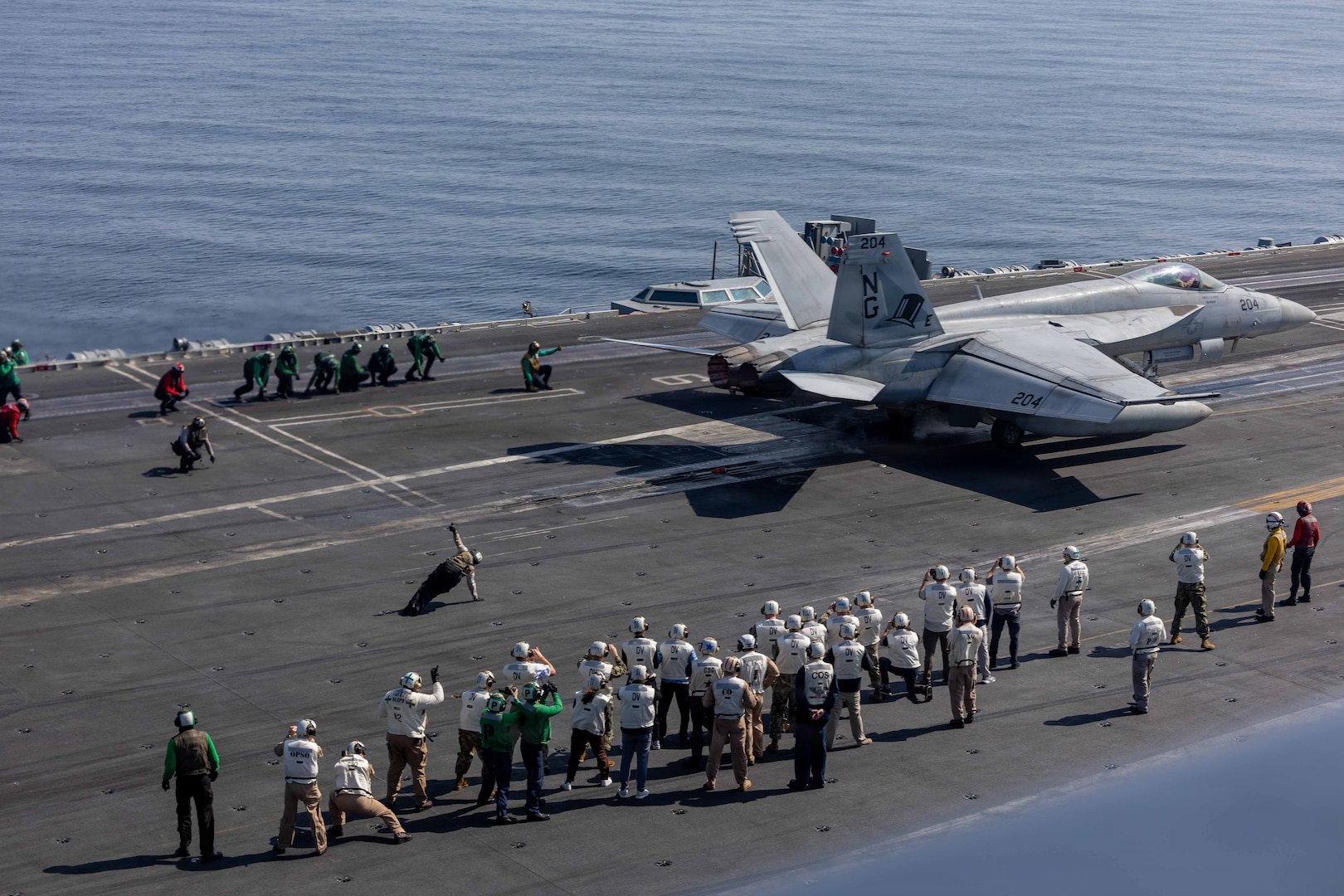 Distinguished visitors observe flight operations on the flight deck of Nimitz-class aircraft carrier USS Abraham Lincoln (CVN 72) in the Arabian Sea, Feb. 7, 2026. Abraham Lincoln is deployed to the U.S. 5th Fleet area of operations to support maritime security and stability in the Middle East. (U.S. Navy photo by Mass Communication Specialist Seaman Hannah Tross)