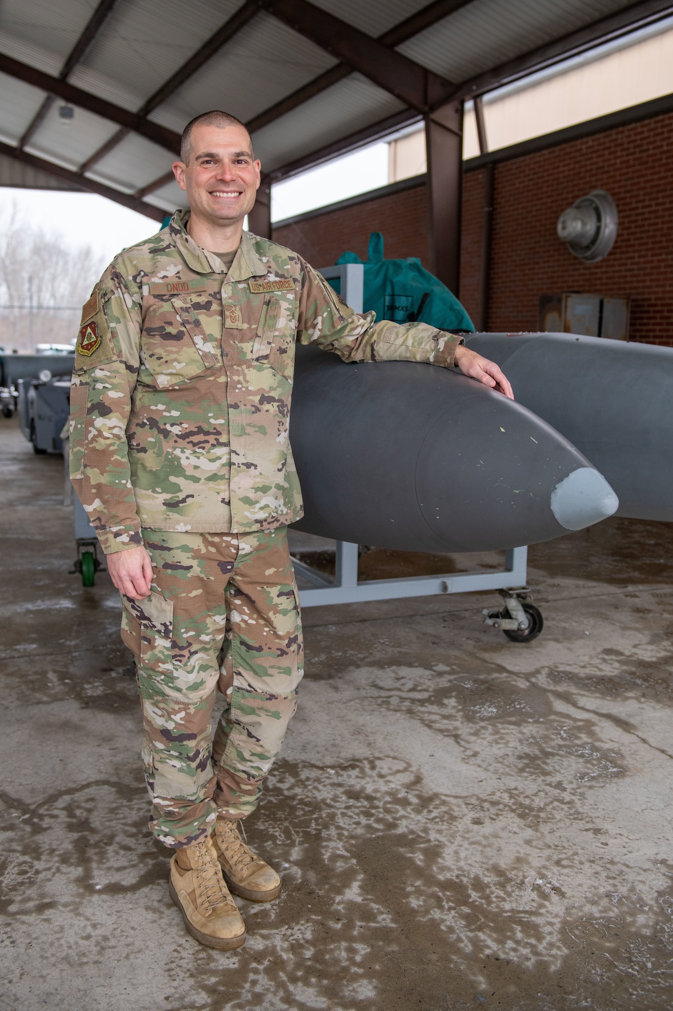 Man poses in front of fuel tank