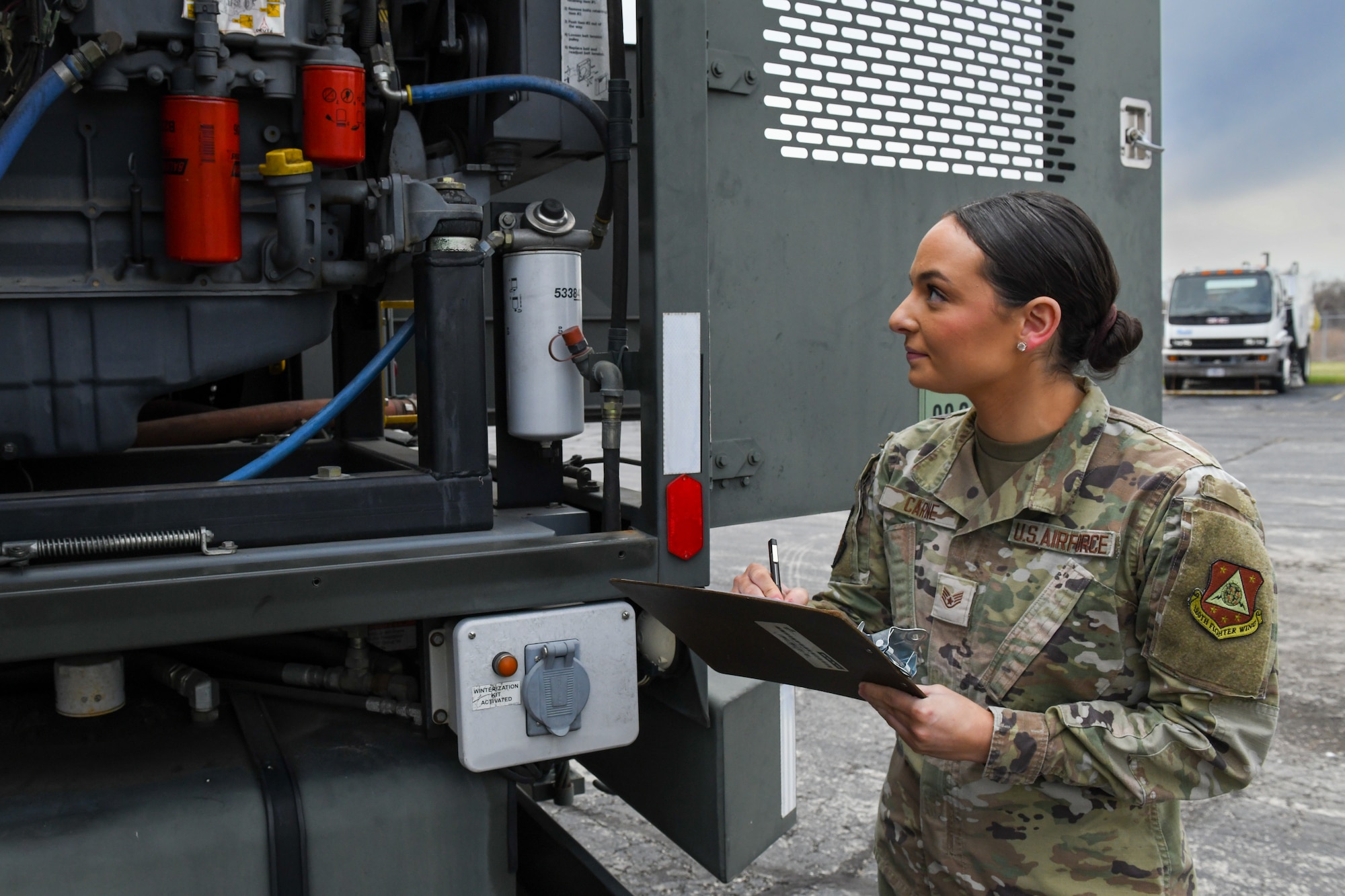 woman inspects truck