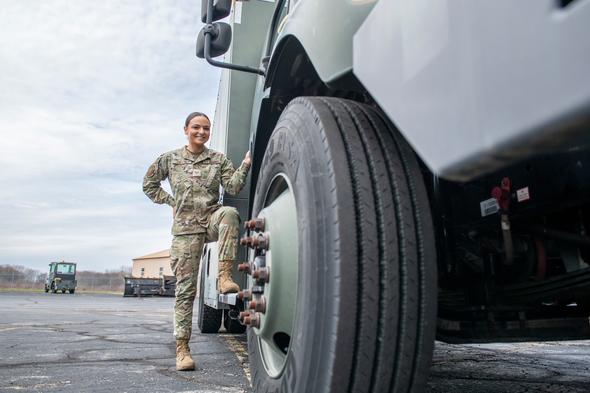woman stands next to truck