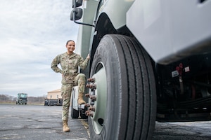 woman stands next to truck