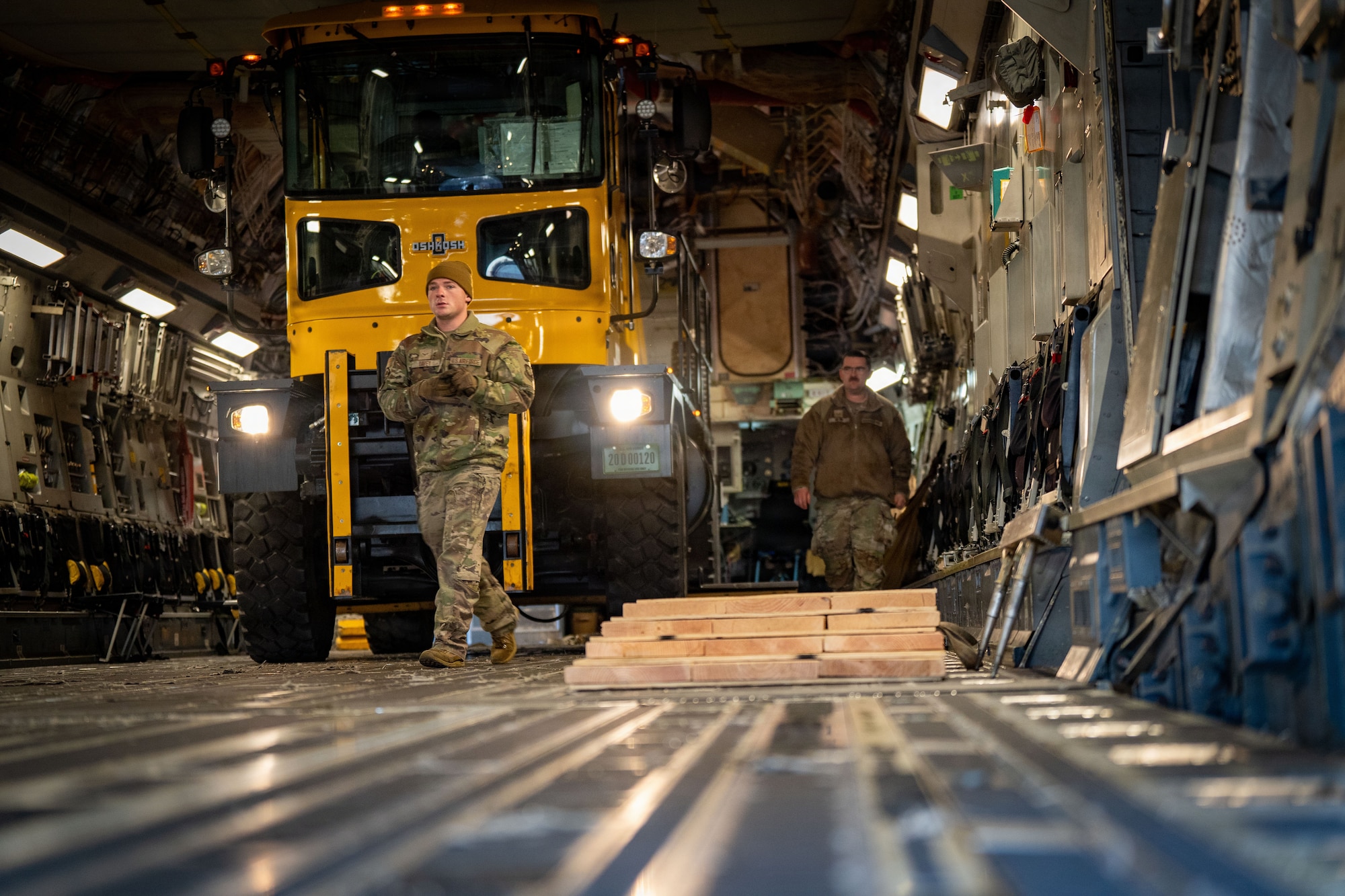U.S. Air Force Senior Airman Jason Davey, 6th Airlift Squadron C-17 Globemaster III loadmaster, Joint Base McGuire Dix Lakehurst, N.J., prepares to marshal a heavy snow plow off a C-17 at Joint Base Andrews, M.d., Jan. 23, 2026. Air Mobility Command mobilized mission-ready Airmen and specialized equipment in support of winter weather preparedness efforts to ensure “America’s Airfield” remained operational amid historic severe weather impacts. (U.S. Air Force photo by 1st Lt. Alexis Kula)