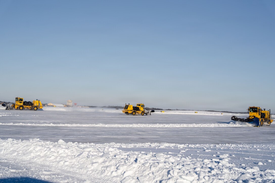 U.S. Air Force Airmen from the 316th Civil Engineer Squadron and Airmen from across Air Mobility Command conduct snow removal operations on the flight line at Joint Base Andrews, Md., Jan. 29, 2026. Air Mobility Command mobilized mission-ready Airmen and specialized equipment in support of winter weather preparedness efforts to ensure “America’s Airfield” remained operational amid historic severe weather impacts. (U.S. Air Force photo by 1st Lt. Alexis Kula)