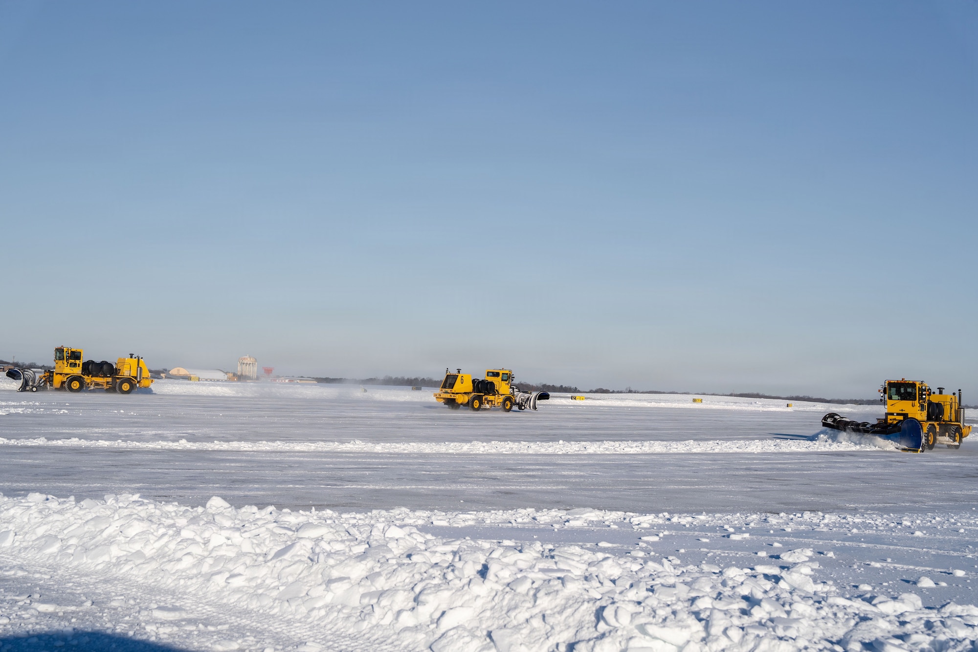 U.S. Air Force Airmen from the 316th Civil Engineer Squadron and Airmen from across Air Mobility Command conduct snow removal operations on the flight line at Joint Base Andrews, Md., Jan. 29, 2026. Air Mobility Command mobilized mission-ready Airmen and specialized equipment in support of winter weather preparedness efforts to ensure “America’s Airfield” remained operational amid historic severe weather impacts. (U.S. Air Force photo by 1st Lt. Alexis Kula)