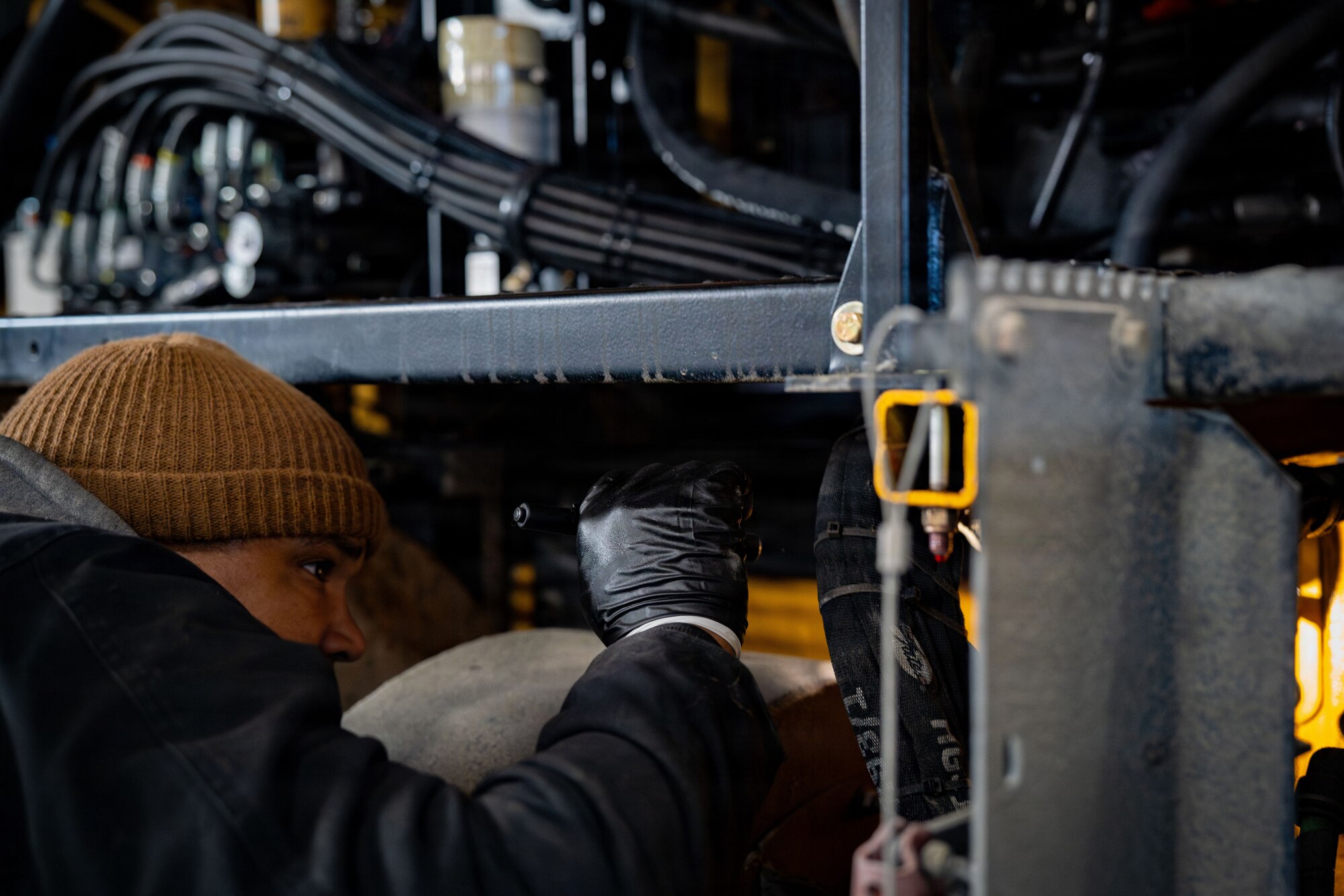 U.S. Air Force Staff Sgt. Owen Gill, 6th Logistics Readiness Squadron vehicle maintenance supervisor, MacDill Air Force Base, Fl., analyzes a snowplow at Joint Base Andrews, Md., Jan. 29, 2026. Air Mobility Command mobilized mission-ready Airmen and specialized equipment in support of winter weather preparedness efforts to ensure “America’s Airfield” remained operational amid historic severe weather impacts. (U.S. Air Force photo by 1st Lt. Alexis Kula)