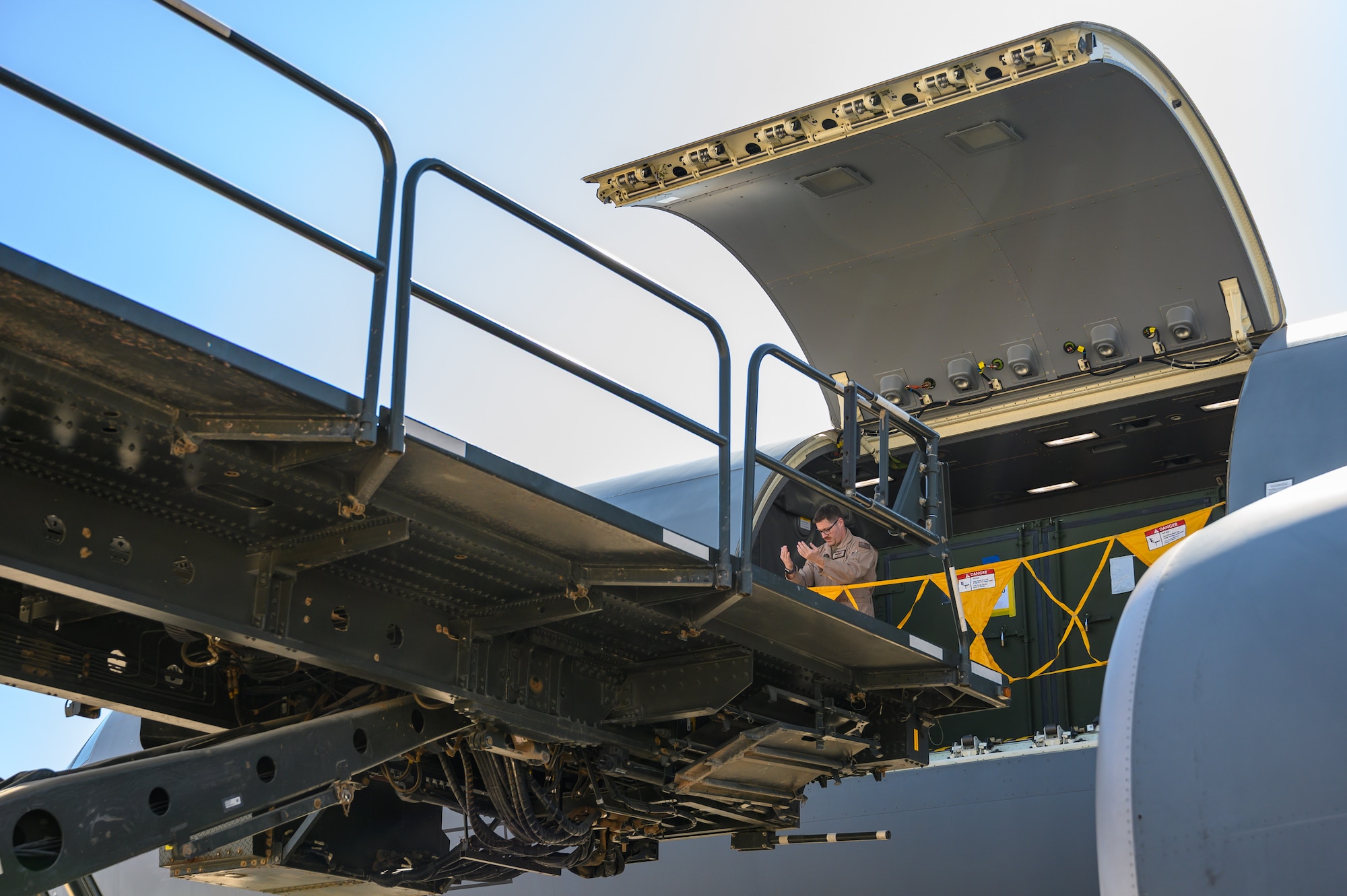 Senior Master Sgt. Pat Martin, 77th Expeditionary Air Refueling Squadron senior enlisted leader, guides a K-loader to the cargo door of a KC-46A Pegasus aircraft after landing in the U.S. Central Command area of responsibility.