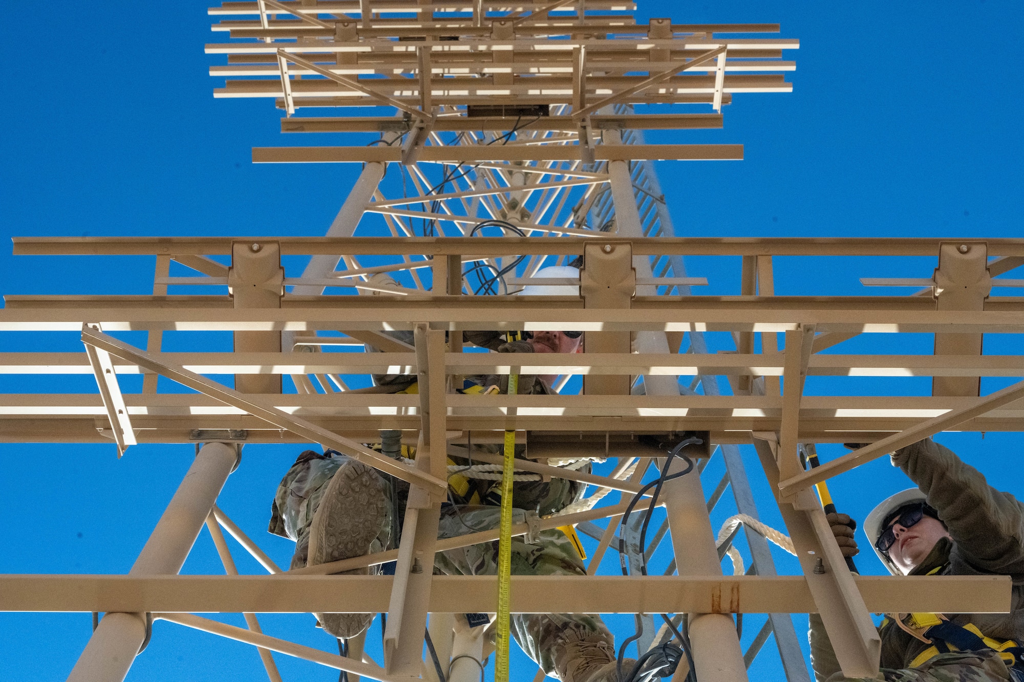 U.S. Air Force Tech. Sgt. Keenan Herlocker, Air Forces Central Deployed Regional Maintenance Center noncommissioned officer in charge, uses a tape measure while adjusting antennae heights on a glide slope in the U.S. Central Command area of responsibility Feb. 5, 2026. The antenna height adjustments fine-tuned glide slope angles to meet flight inspection and certification requirements. (U.S. Air Force photo by Senior Airman Kari Degraffenreed)